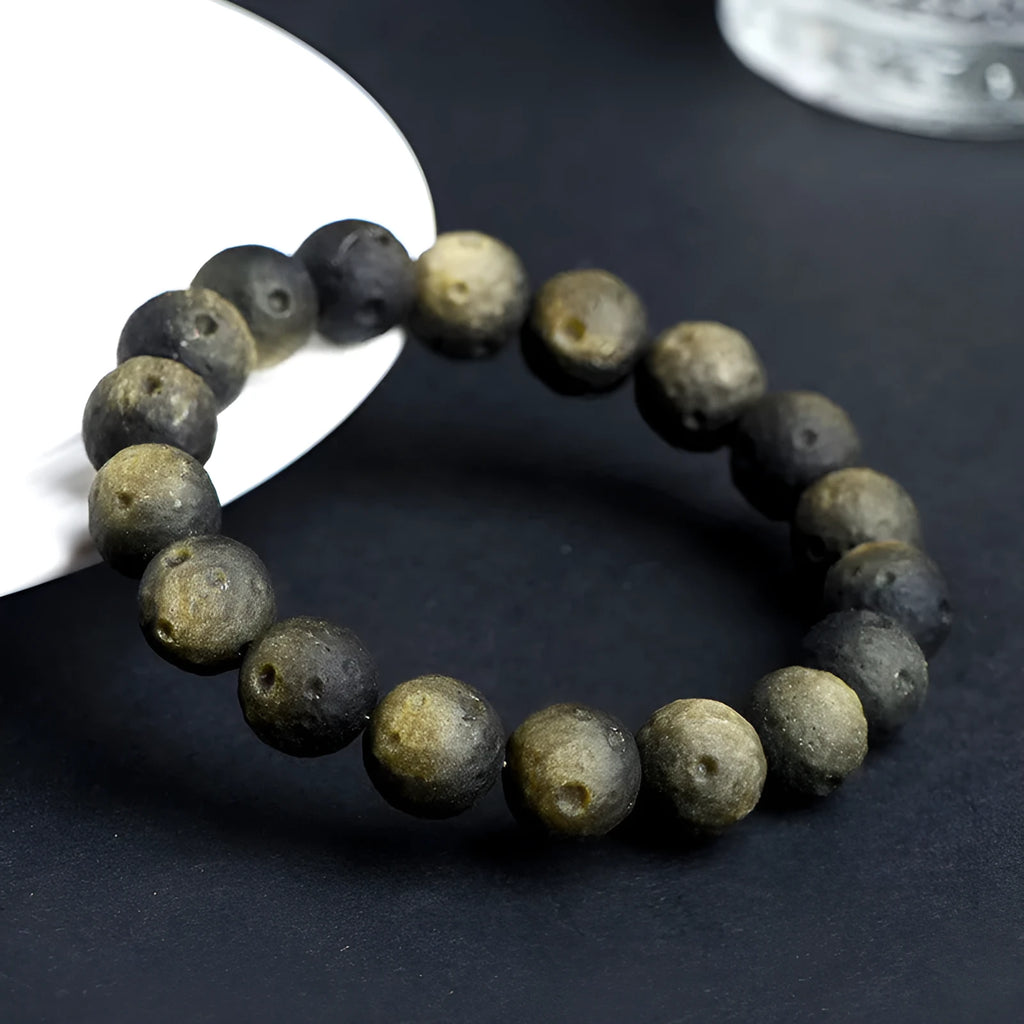 Obsidian crater ball bracelet with natural grinding texture in silver stone meteorite colour