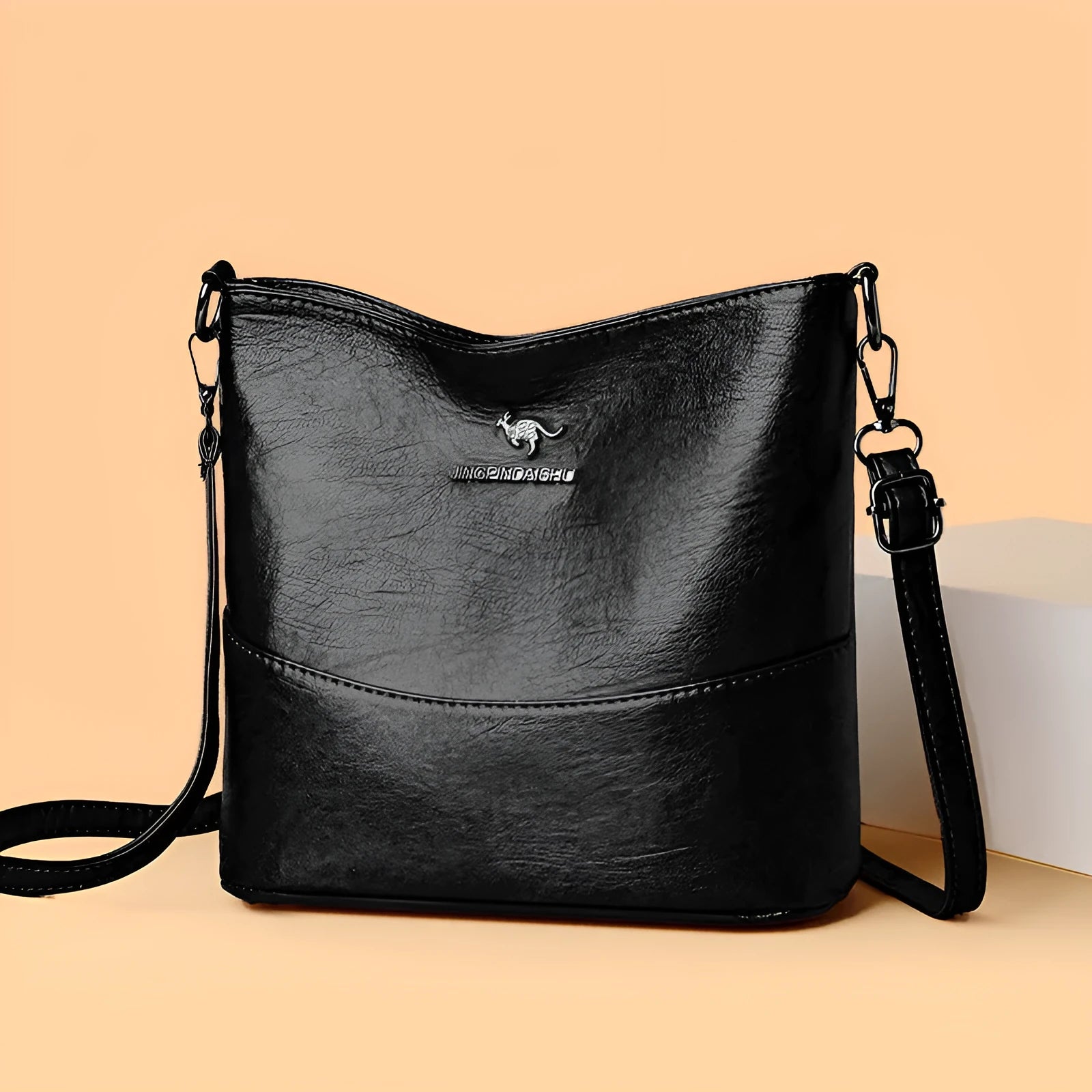 Women's soft leather large capacity bucket shoulder bag in minimalist luxury style with sewing line details.