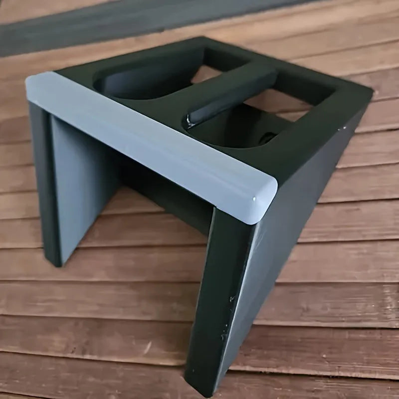 Black plastic punk-style pistol display stand on a flat surface.