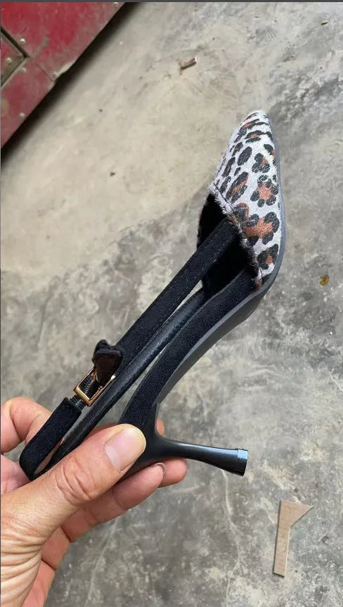 Leopard print suede women's sandals with a pointed toe and scattered decorative details on a high heel