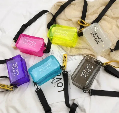 Transparent square jelly shoulder bag with adjustable strap in various colours on a white background.
