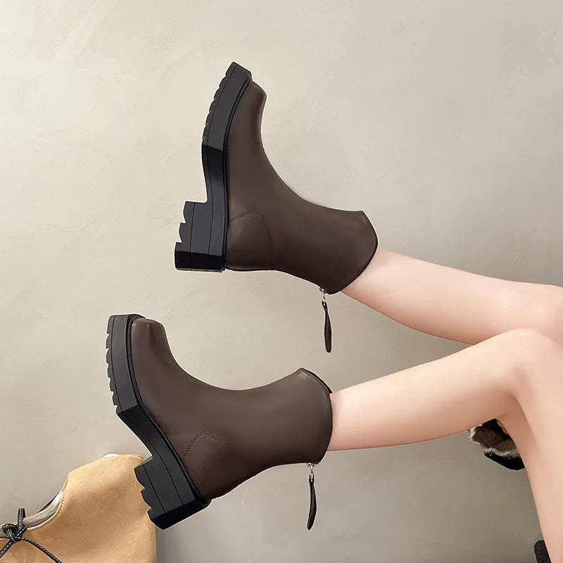 Black square toe platform Martin boots for women with a chunky rubber sole and back zip.