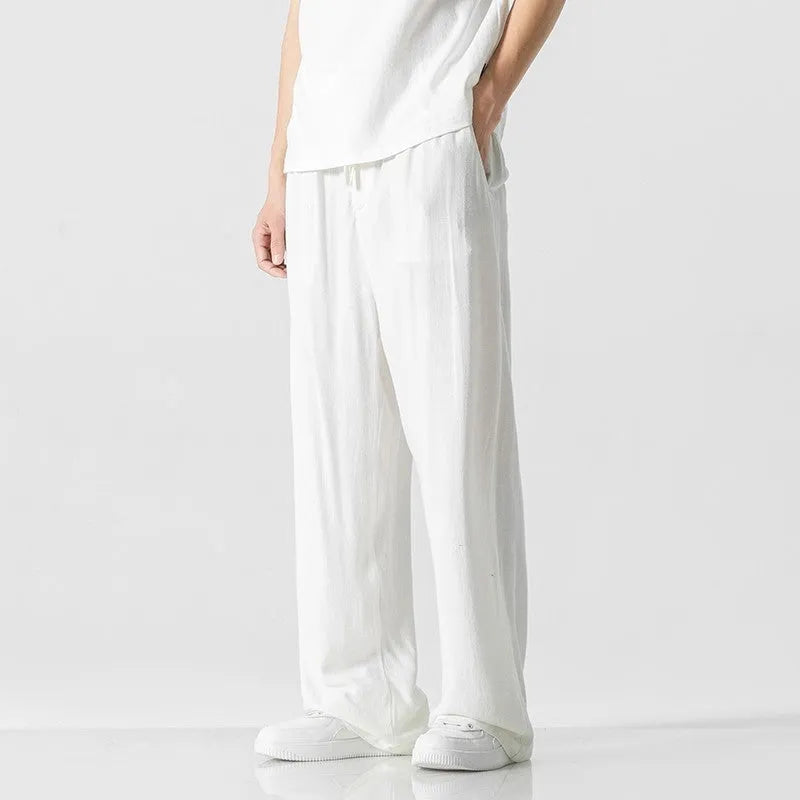 Men's beige bamboo fibre loose straight-leg casual trousers with a drawstring waist, shown on a hanger.