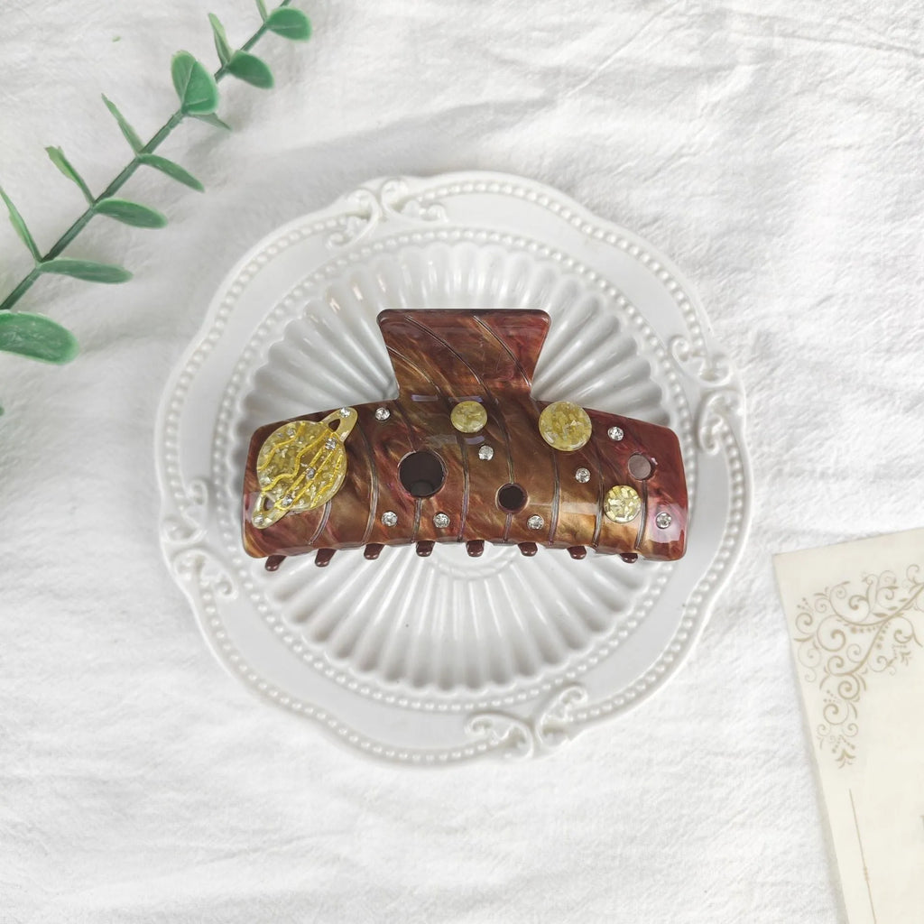 Oversized women's hair barrette with star and moon celestial design in starry sky colour options