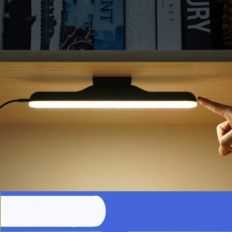 Modern white rechargeable LED desk lamp with touch control on a wooden desk.