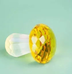 Colourful crystal mushroom decoration in modern geometric style on a white background.