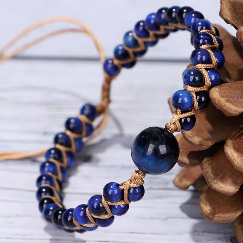 Handwoven geometric pull bracelet made from blue Tigereye stone beads with amethyst details