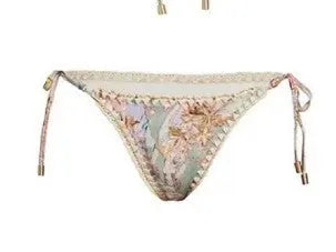 Women's creamy-white floral print bikini set with top, briefs, and skirt laid flat.