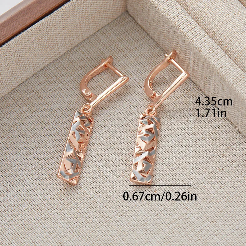 A pair of women's rectangular hollow stud earrings with a two-tone metal finish.