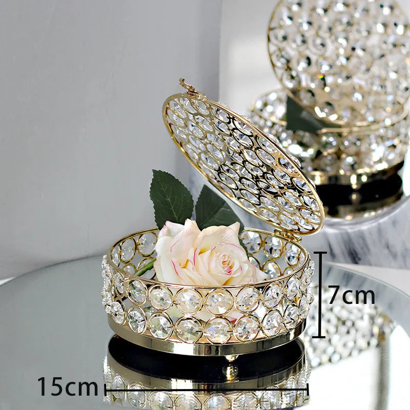 French gold metal jewellery box with a transparent crystal glass lid on a table.