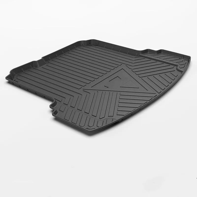 Black carbon fibre pattern TPE trunk pad installed in a car boot showing custom fit and textured surface