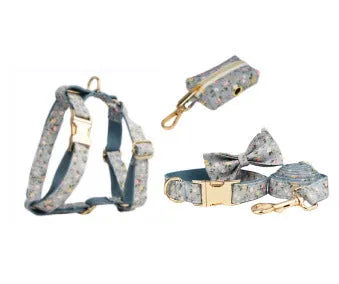 Blue floral pattern dog collar accessories set with adjustable collar, matching leash, bow, vest, and poop bag