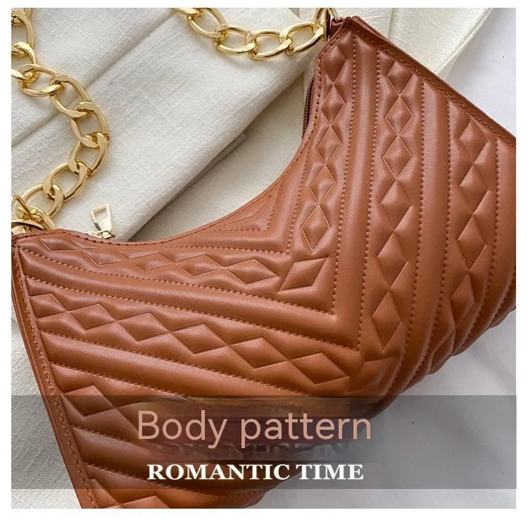 Brown pleated PU leather baguette bag with a gold-tone chain shoulder strap and a soft top handle.