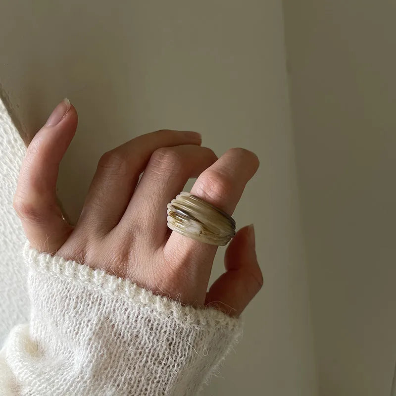 Resin ring with irregular geometric wide band design in brown and white colour options
