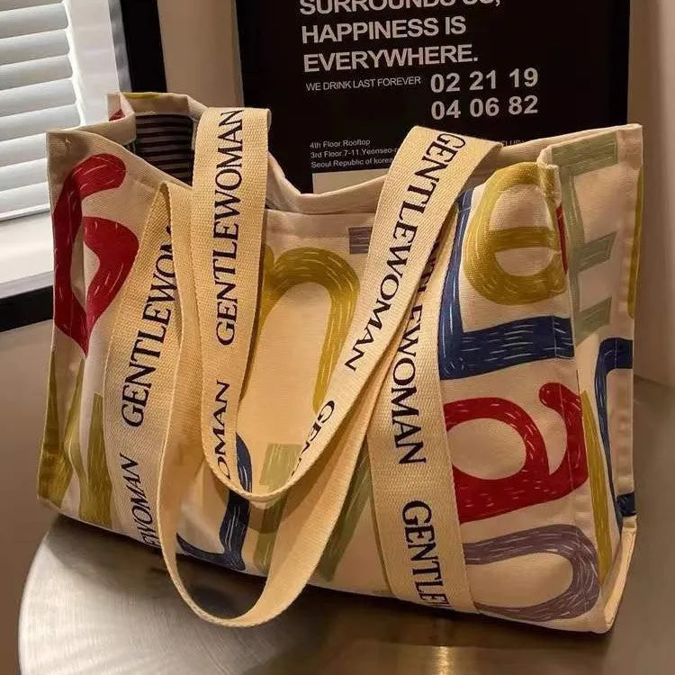Large canvas tote bag with printed design, shown in available colour and pattern options.