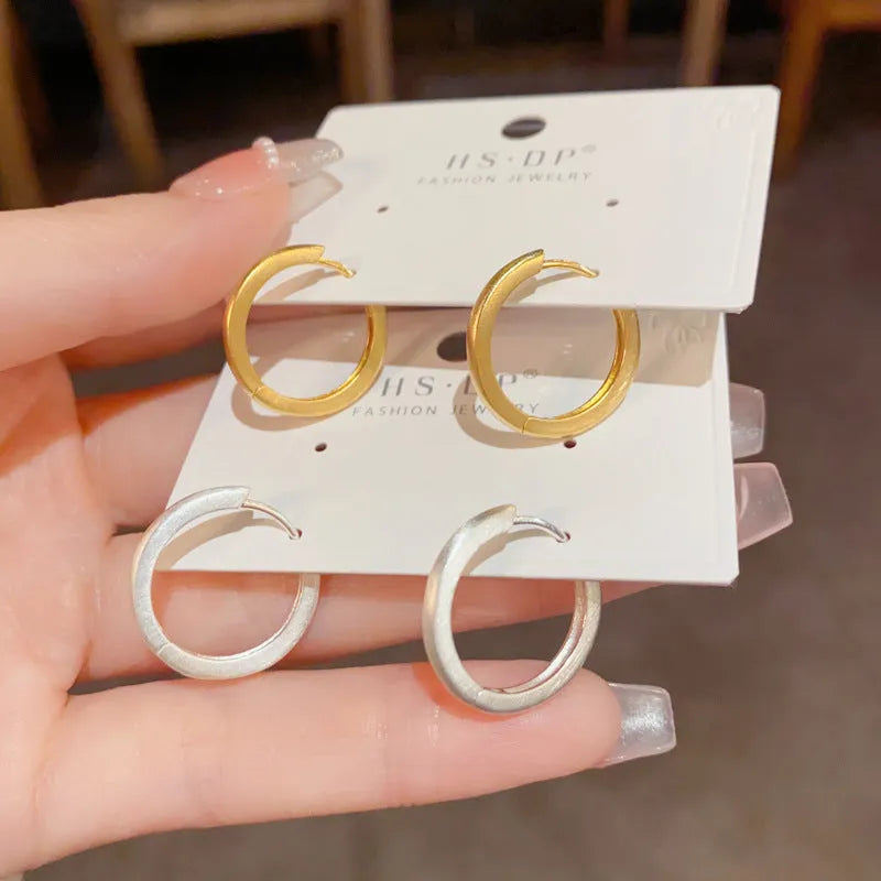 Geometric women's ear clip with real gold plating in gold colour showing round eyelet design