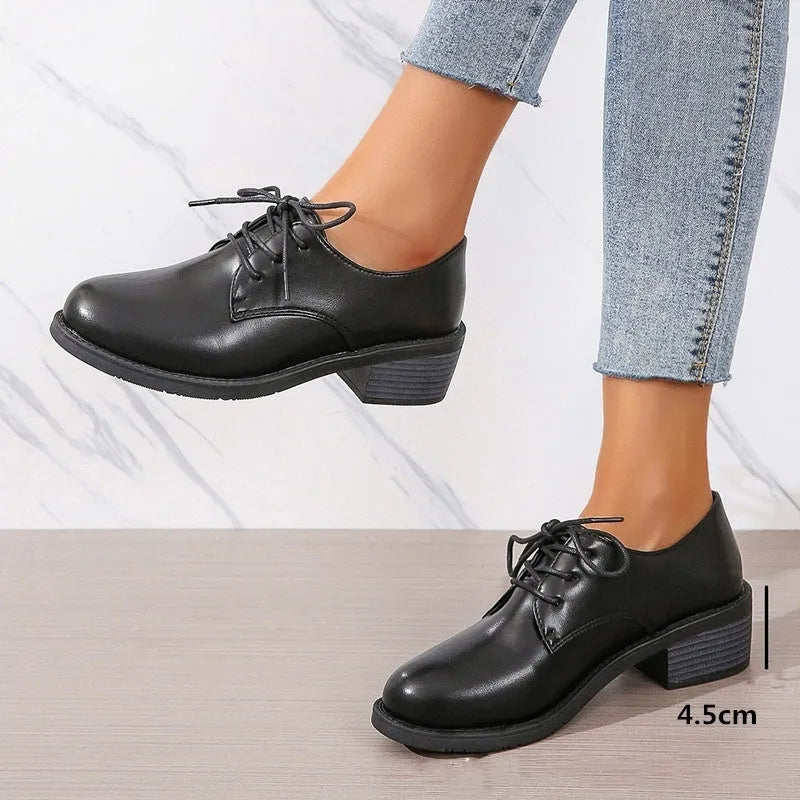 Black women's leather shoes with chunky heel, rubber sole, and low-top design for work and casual wear