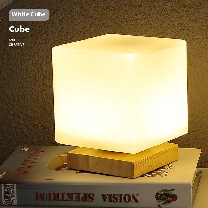 Nordic solid wood USB table lamp in a geometric shape on a wooden surface.