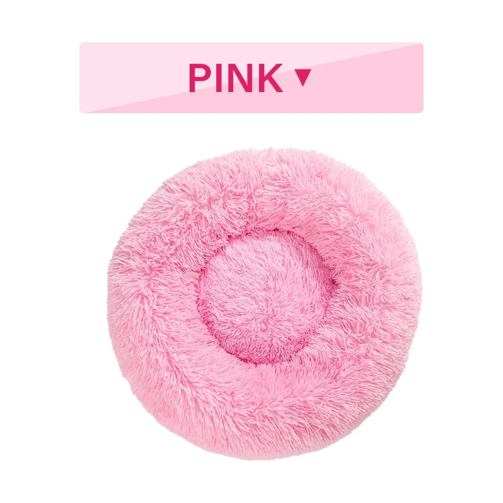 A round donut-shaped dog bed with a raised plush rim, shown in a light grey colour.
