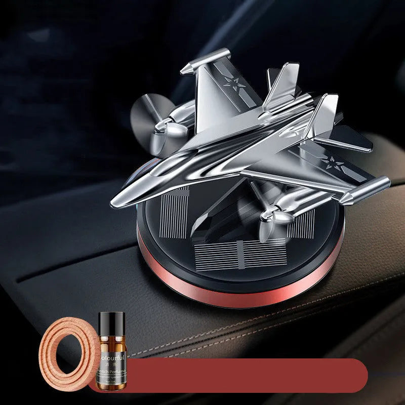 Solar powered silver rotating fighter jet model perfume ornament for car dashboard.
