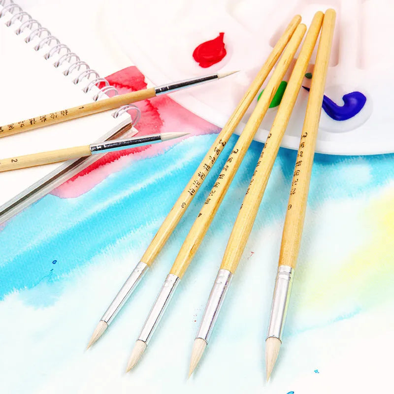 Six wooden-handled pointed hook line pen brushes with wool tips arranged together