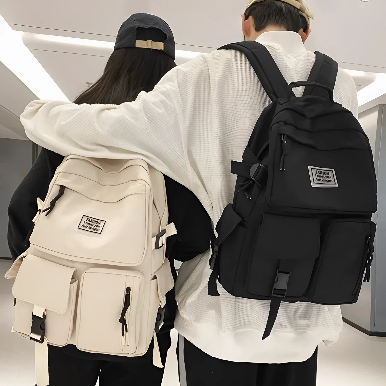Black and white nylon student backpack with laptop compartment, showing three-dimensional pocket.