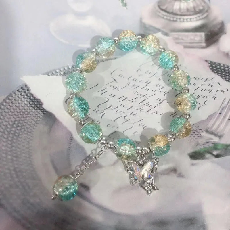 Chinese style handmade glass bead bracelet with bamboo joint elements on a white background.