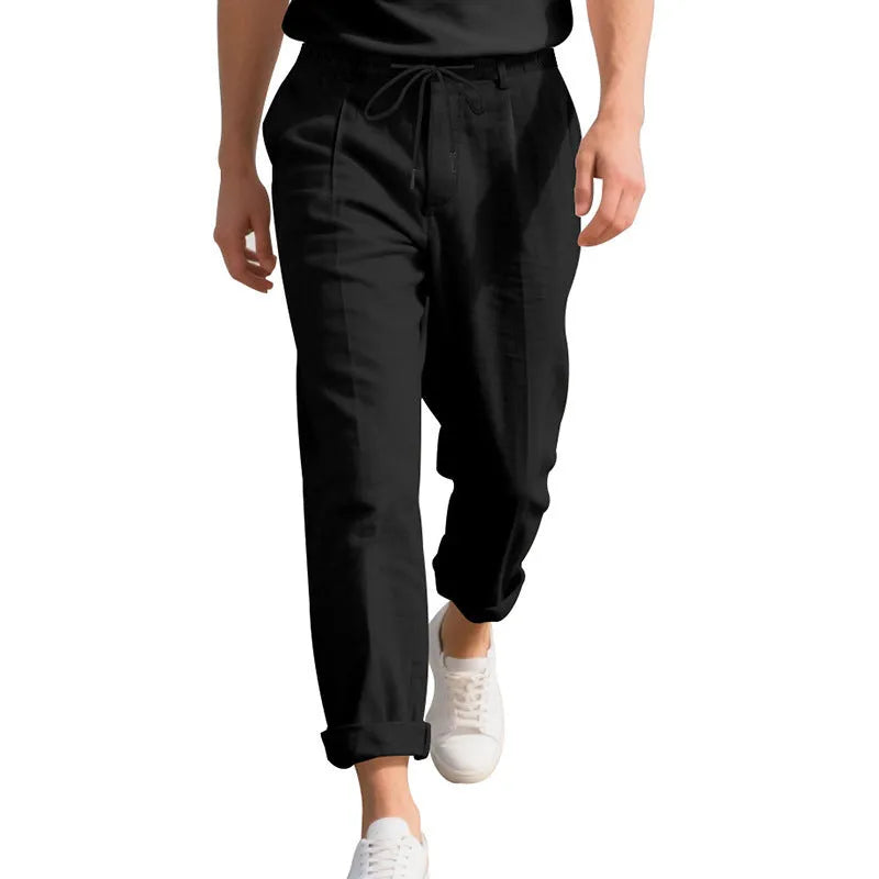 Men's light beige linen casual trousers with a drawstring waist and straight leg on a hanger.