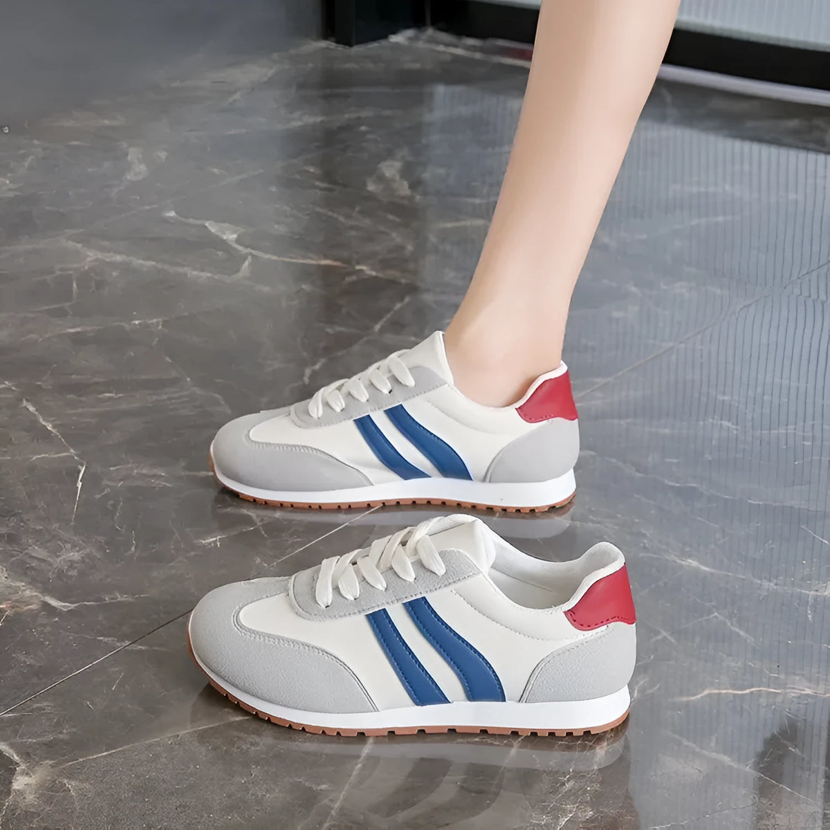 Blue and grey Cortez-style striped casual trainers with round toe and flat rubber sole.