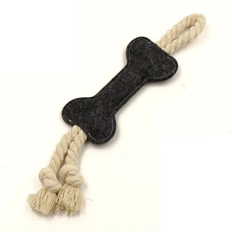 Bone-shaped felt dog chew toy with rope knot interior in blue, shown next to a tape measure indicating 16 cm length.