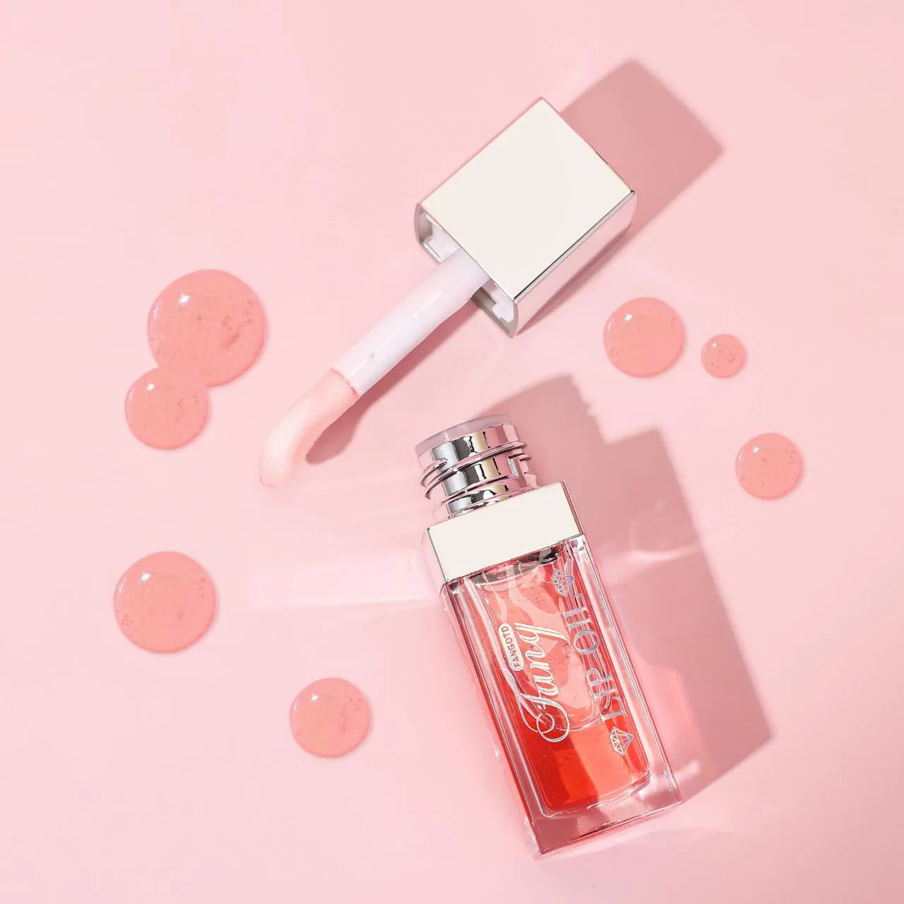 Mint lip essence oil tube in one of five bright colours, shown as a dual-use lip gloss and lipstick.