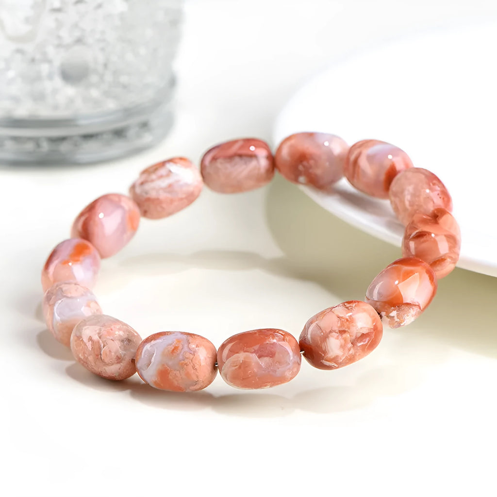 Natural cherry agate bracelet with geometric barrel beads and a Ruyi design detail.