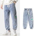 Men's loose-fit tapered cotton trousers in black, blue or grey with mid-waist design