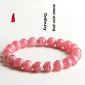Women's red rhodochrosite crystal bracelet with geometric beads and Longevity Lock element.