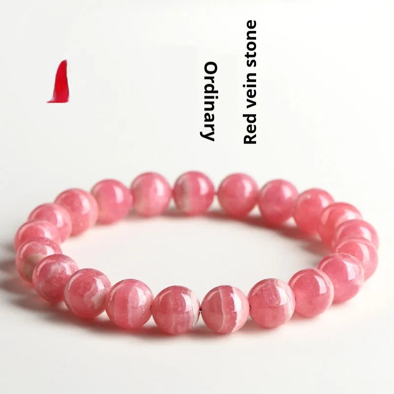 Women's red rhodochrosite crystal bracelet with geometric beads and Longevity Lock element.