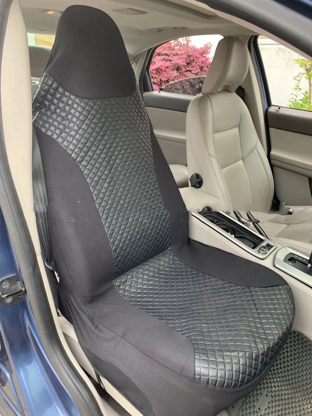 Black quilted car seat cover made from PU and polyester fabric with plastic installation hooks.