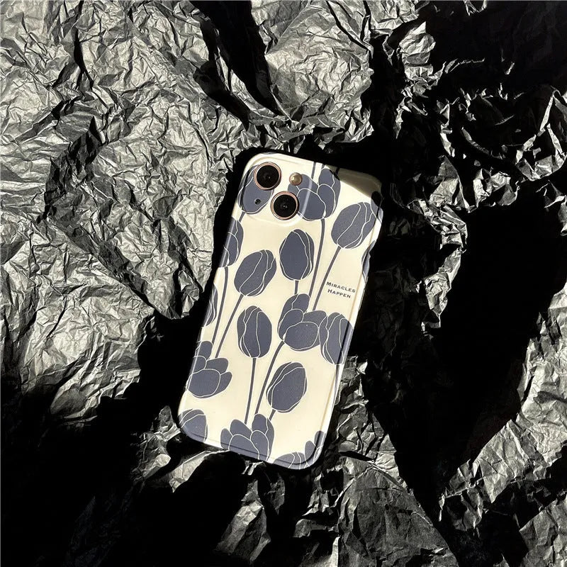 Black silicone iPhone case with tulip flower design shown on mobile phone