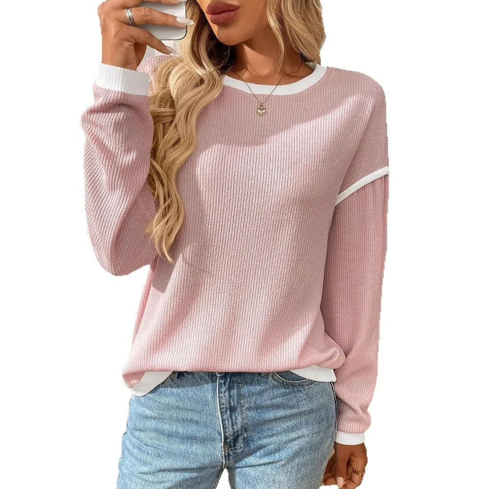Loose women's round neck long sleeve polyester pullover top on a hanger