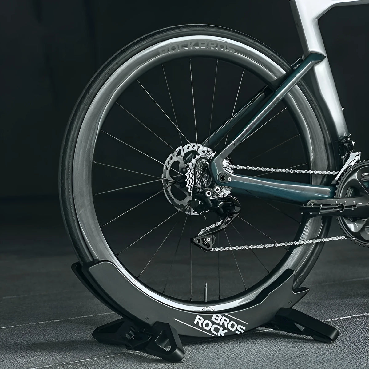 Black and green ABS plastic bicycle parking rack holder with fixed wall mounting bracket.