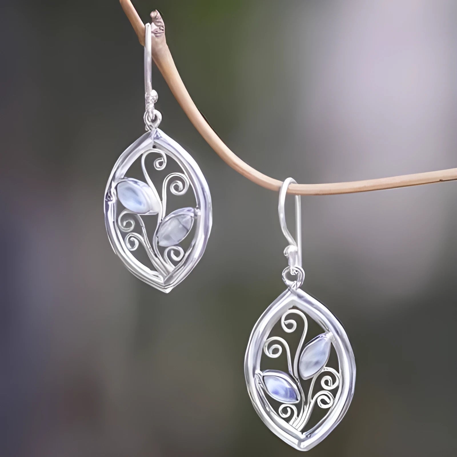 Women's silver alloy earrings with leaf designs and embedded colourful moonstones