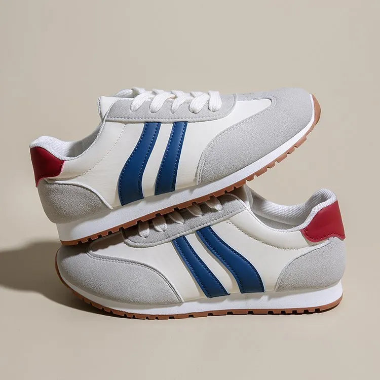Blue and grey Cortez-style striped casual trainers with round toe and flat rubber sole.