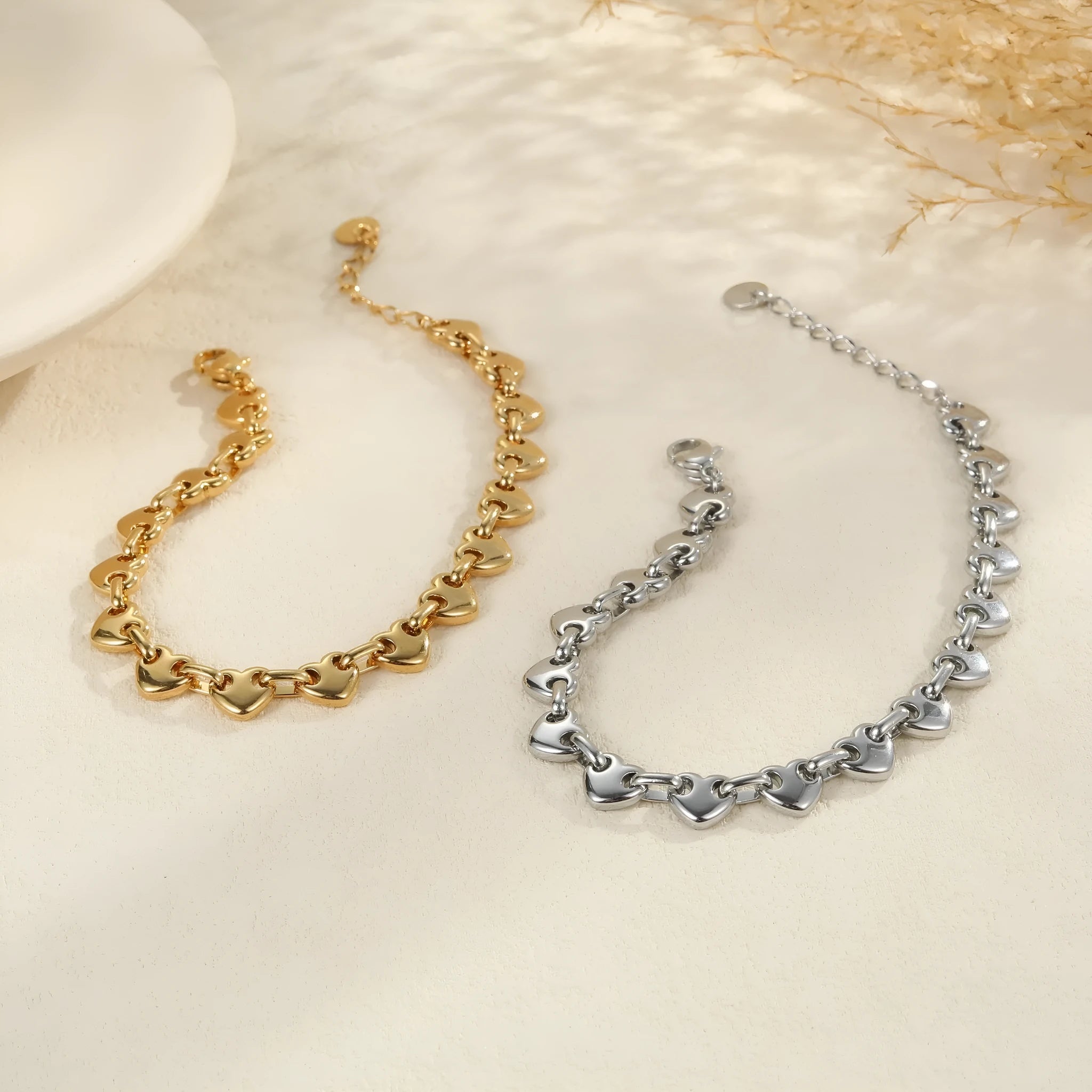 Hollowed-out heart bracelet in stainless steel with 18K gold plating, showing geometric design and electroplated finish