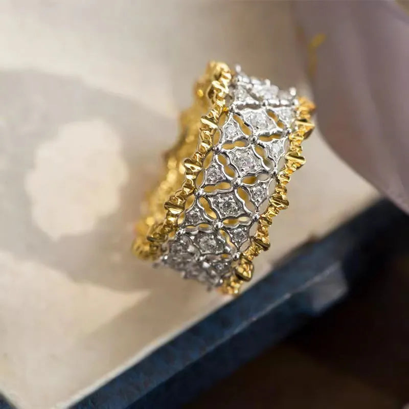Gold two-tone geometric zircon ring on a copper band, showing round design detail.