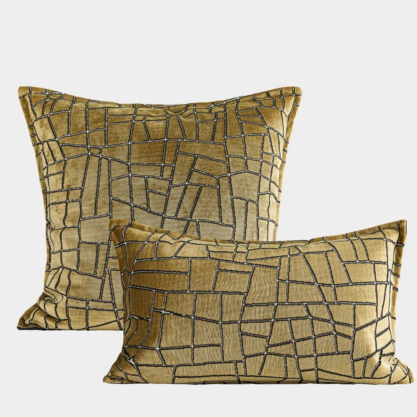 Geometric abstract patterned cushion in local gold colour, shown in square and lumbar sizes on a grey sofa.