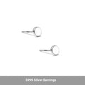 A pair of round, flat S999 sterling silver bone stud earrings on a plain background.
