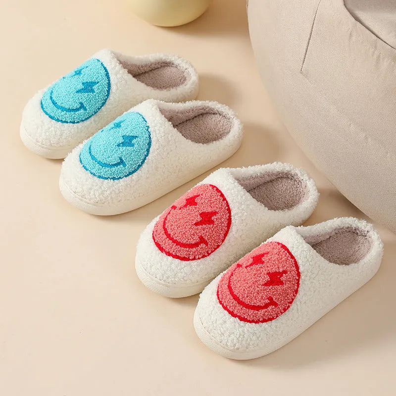 Women's plush home slippers in cartoon love style print with round toe and non-slip PVC sole.