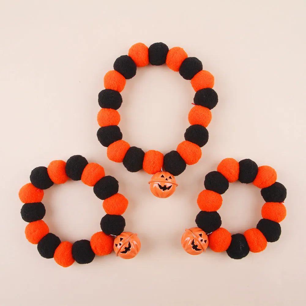 Orange and black pumpkin-shaped adjustable cat collar for Halloween.