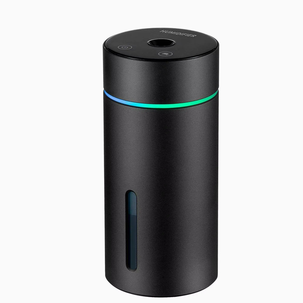 Compact aluminium car humidifier and essential oil diffuser with night light on a desk.