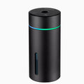 Compact aluminium car humidifier and essential oil diffuser with night light on a desk.