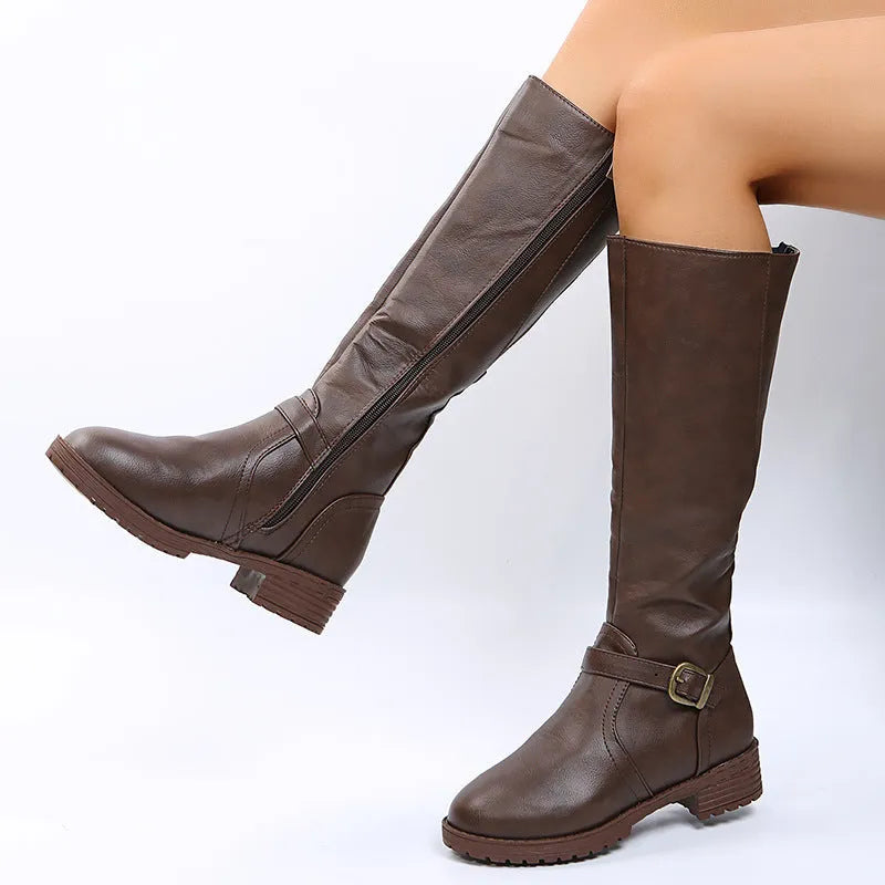 Women's black knight-style ankle boots with a buckle strap and square heel on a white background.